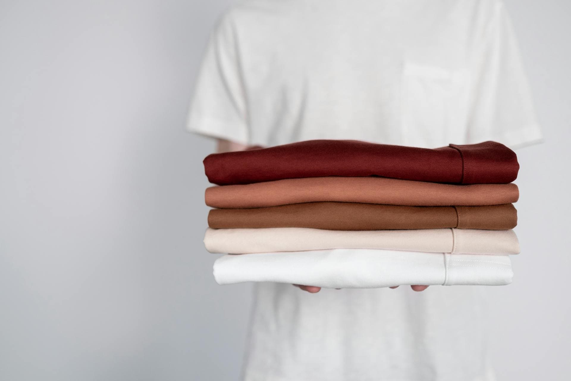 Freshly folded clothes in warm neutral colours