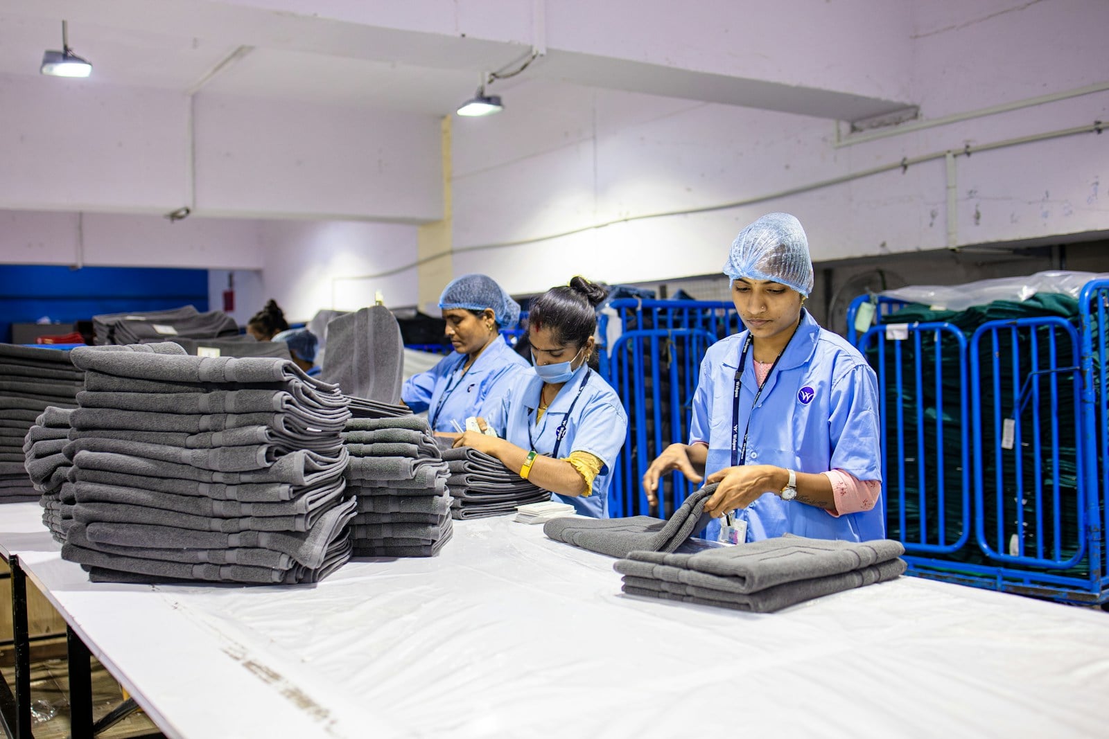 Professional laundry team folding hotel towels