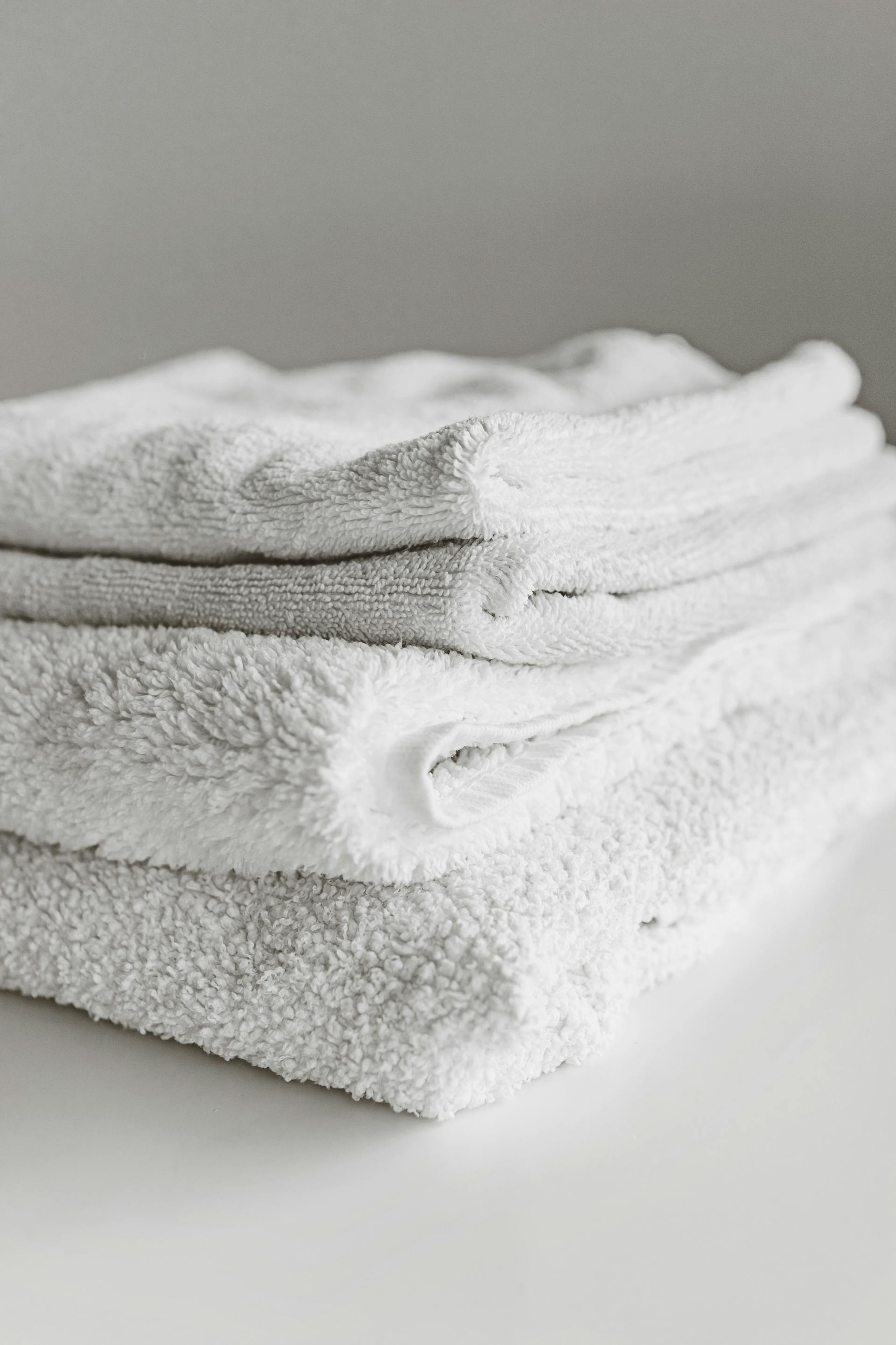 Folded stack of fresh white towels, ready for delivery