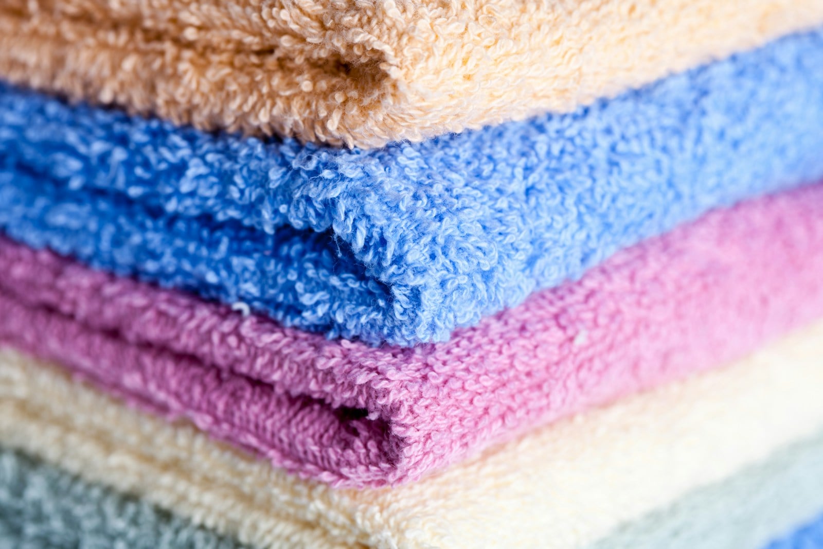 Bright clean towels coming out of a hotel-grade wash cycle