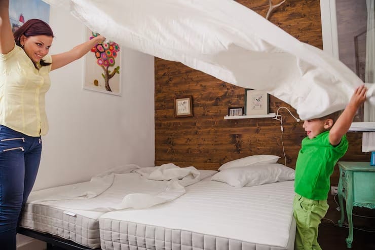 Woman with kid playing with sheet 23